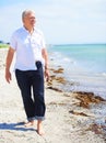 Beach, walking and elderly man on a travel tropical vacation, holiday or weekend trip in summer. Adventure, outdoor and Royalty Free Stock Photo