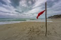 Beach warning flag at the beautiful beach of Varadero in Cuba at rainy and stormy day