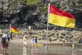 Beach warning flag standing on the sands of St.Agnes beach cove Royalty Free Stock Photo