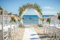 Beach Wedding Ceremony Setup With Ocean View, Beach wedding set up with white chairs and a floral arch, AI Generated Royalty Free Stock Photo