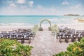 Beautiful beach wedding venue setting with flowers, floral decoration on arch, panoramic ocean view Royalty Free Stock Photo