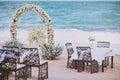 Beach wedding venue setting with flower decoration on arch, panoramic ocean view Royalty Free Stock Photo