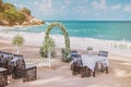 Beach wedding venue setting with flower decoration on arch, panoramic ocean view Royalty Free Stock Photo