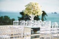 Beach wedding venue setup with roses and white flower on the mirror box vase decoration Royalty Free Stock Photo