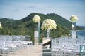 Beach wedding venue setup with roses and white flower on the mirror box vase decoration Royalty Free Stock Photo