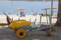 Beach wheelchair near reservoir shore ready to use Royalty Free Stock Photo