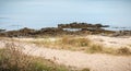 Beach of the wild coast of the island of yeu with its fine sand and its rocks Royalty Free Stock Photo