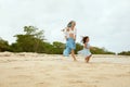 Beach. Woman And Kid Walking On Ocean Coast. Young Mother In Fashion Maxi Dress With Daughter At Tropical Resort. Royalty Free Stock Photo