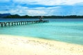 Beach and wooden dock on Bolilanga Island. Togean Islands. Indonesia. Royalty Free Stock Photo