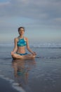 Beach yoga practice in Bali. Lotus pose. Padmasana. Hands in gyan mudra. Meditation and concentration. Zen life. Relaxation of Royalty Free Stock Photo