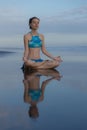 Beach yoga practice in Bali. Lotus pose. Padmasana. Hands in gyan mudra. Meditation and concentration. Zen life. Relaxation of Royalty Free Stock Photo