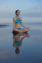 Beach yoga practice in Bali. Lotus pose. Padmasana. Hands in gyan mudra. Meditation and concentration. Zen life. Relaxation of Royalty Free Stock Photo