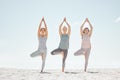 Beach yoga stretching exercise friends or people for balance, flexibility and relax body. Zen, peace and healthy women