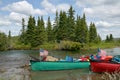 Beached American canoes on Alaskan river bank Royalty Free Stock Photo