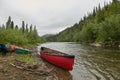 Beached canoe and equipment on river in Alaska Royalty Free Stock Photo