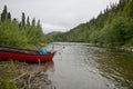 Beached canoe on remote, wild Alaskan riverbank Royalty Free Stock Photo