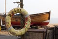 Beached fishing boat with lifebuoy in Kent, England