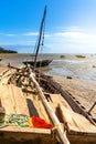 Beached sailing dhow on the mud flats of the outgoing tide Royalty Free Stock Photo