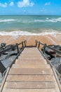 Beachfront landscape of a wooden stair leading down to the sea Royalty Free Stock Photo