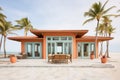 beachfront property with clay tiles and palm trees