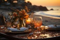 Beachfront romance Sunset dinner setting by the sea Royalty Free Stock Photo