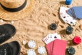 Beachpoker. Chips and cards on the sand. Around the seashells, hat and flip flops. Top view Royalty Free Stock Photo