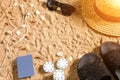 Beachpoker. Chips and cards on the sand. Around the seashells, sunglasses and flip flops. Top view Royalty Free Stock Photo