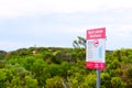 Beachport, Australia - December, 30, 2019: `Rock Lobster Sanctuary` sign on a beach with Cape Martin Lighthouse on a background