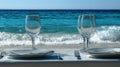 Romantic Beach Dinner Setting with Wine Glasses and Ocean View Royalty Free Stock Photo