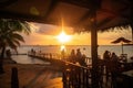 beachside eatery with view of sun setting over the water