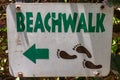 Beachwalk sign with footprints and arrow