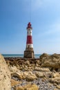 A view of Beachy Head lighthouse on the Sussex coast, with a blue sky overhead Royalty Free Stock Photo