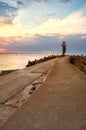 Beacon at the end of a pier in Swinoujscie at sunset, Poland