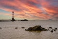 The beacon lighthouse under the gorgeous sunset by the sea Royalty Free Stock Photo