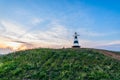 Beacon with the pointer on the hill in sunset light Royalty Free Stock Photo