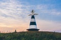 Beacon with the pointer on the hill in sunset light Royalty Free Stock Photo