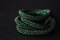 Bead crochet necklace green color on a dark background