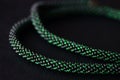 Bead crochet necklace green color on a dark background