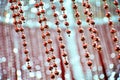 Bead curtain with cream-colored walls. Selective focus diamond bead can be used as background or texture Royalty Free Stock Photo