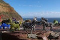 Beaded african artwork or curios placed on a rock wall at Chapmans Peak, Cape Town