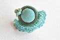 A beaded brooch on a white surface Royalty Free Stock Photo