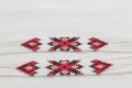 Beaded ethnic red and black necklace on white fabric background. Female accessories, decorative ornaments and jewelry. Royalty Free Stock Photo