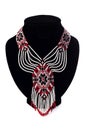 Beaded ethnic red necklace on black velvet bust isolated on white background. Female accessories, decorative ornaments and jewelry Royalty Free Stock Photo