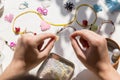 Beading workplace with hands in the process of handicraft