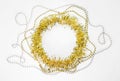 Beads, chain of balls, empty blank circle yellow golden tinsel. New year decorations for text on a white background. Christmas Royalty Free Stock Photo