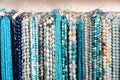 Beads from gems strung on thread in jewelry accessories store