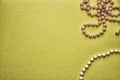Beads on a gold background, flat lay, toned photo. Royalty Free Stock Photo