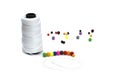 Large spool of thread with beads for making beads. Royalty Free Stock Photo