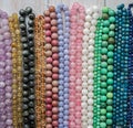 Beads from various natural stones are strung on threads.