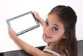 Beaitiful pre-teen girl using a tablet computer